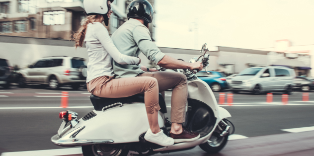 moped riding on city streets